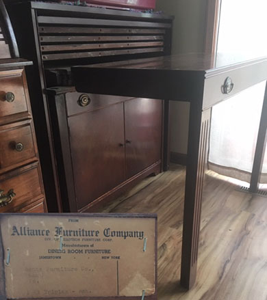 Alliance Furniture dining room table in a cabinet